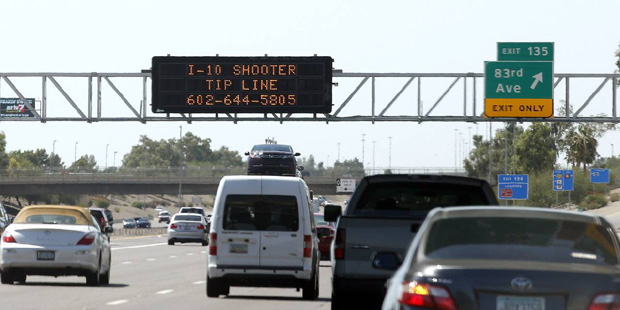 A sign still displays a shooter tip line above Interstate 10, Friday, Sept. 11, 2015, in Phoenix. A...