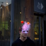 A man wears a masquerade mask and a headband with lighted jack-o-lanterns as he stands outside of an art museum in Beijing, Saturday, Oct. 31, 2015. Although growing in popularity, Halloween is not widely celebrated in China. (AP Photo/Mark Schiefelbein)