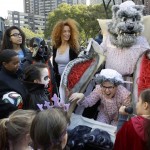 Dressed characters from "Little Red Riding Hood", Amy Mahoney, as the grandmother, her husband Michael, as the Big Bad Wolf and daughter Eva, as the Little Red Riding Hood, bottom right, participate in the Lincoln Center Halloween celebration Saturday, Oct. 31, 2015, in New York. (AP Photo/Mary Altaffer)