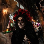 Sharon Hagale, center, waits with others for the start of the Greenwich Village Halloween Parade, Saturday Oct. 31, 2015, in New York.  (AP Photo/Tina Fineberg)