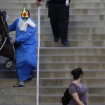 A man wearing a custom walks down the steps with a baby stroller after attending Stan Lee's Comikaze Expo at the Los Angeles Convention Center, Saturday, Oct. 31, 2015, in Los Angeles. (AP Photo/Jae C. Hong)