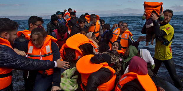 Refugees arrive on a dinghy from the Turkish coast to the northeastern Greek island of Lesbos, Thur...