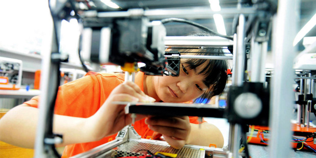 A worker assembles a 3D printer in a factory in Qingdao in eastern China's Shandong province, Tuesd...