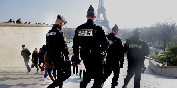 French gendarmes officers patrol near the Eiffel Tower, in Paris, Monday Nov. 23, 2015.  French Pre...