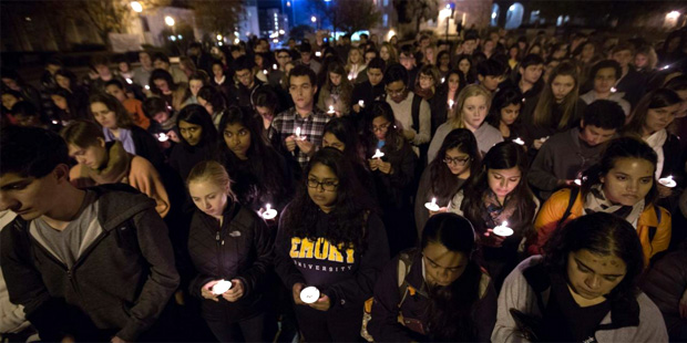 People hold candles during a vigil on Emory University's campus Monday, Nov. 16, 2015, in Atlanta, ...