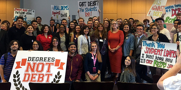 Rep. Kyrsten Sinema (in red dress, middle right), meets with Arizona State University students to d...