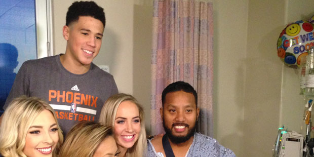 Phoenix Suns guard Devin Booker visits with a patient at St. Luke’s Medical Center....