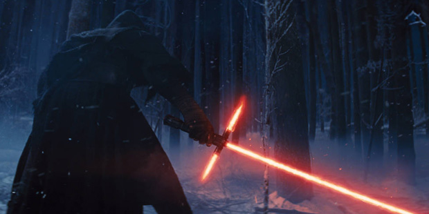 This photo provided by Disney shows, Adam Driver as Kylo Ren with his Lightsaber in a scene from th...