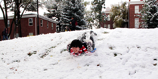 Northern Arizona University freshman Paxton Gyves sleds down a hill on the Flagstaff, Ariz., campus...