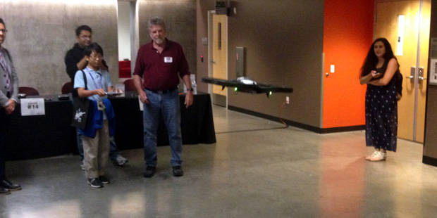 An exhibit visitor and Cronkite professor Steve Doig fly a drone on Cronkite's first annual Innovat...