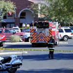 Emergency officials work at the scene of a shooting that authorities claim involved Rep. Gabrielle Giffords, D-Ariz., Saturday, Jan. 8, 2011. (AP File Photo)