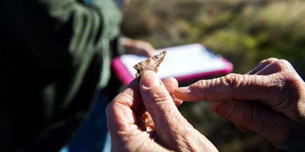 A late archaic Arrowhead is passed around after being found by volunteers in Perry Mesa, Ariz. (Pho...