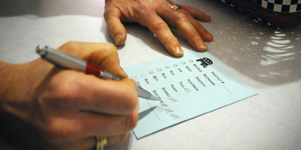 FILE - In this Jan. 3, 2012 file photo, votes are tallied during a caucus of precinct 42 near Smith...
