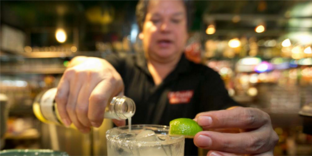 In this Monday, April 28, 2014 photo, bartender Mario Sanchez crafts a margarita cocktail at the ba...