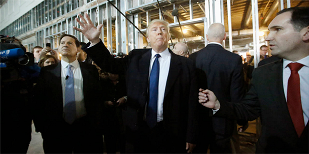 Republican presidential candidate Donald Trump enters the ballroom during a tour of the Old Post Of...