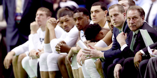 The Michigan State bench watches during the final moments of a first-round men's college basketball...
