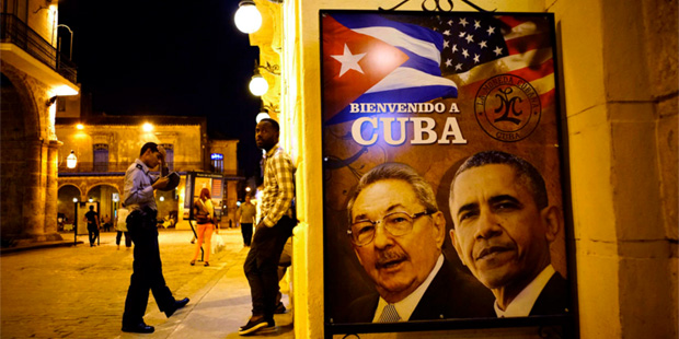 A poster featuring portraits of Cuba's President Raul Castro, left, and U.S. President Barack Obama...