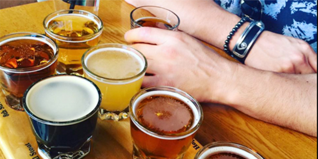 A customer enjoys a taster flight of Four Peaks Brewing (Facebook/Four Peaks Brewing Company)...