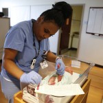 
              In this Thursday, May 12, 2016, Community Hospital North obstetrician technician Sherron Harris collects a blood sample from newborn Ellie Bailey in the nursery at Community Hospital North in Indianapolis. Ellie is among some 4 million newborns in the United States who will have blood drawn this year to screen them for serious inherited diseases. (AP Photo/Michael Conroy)
            