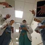 In a Friday, May 6, 2016 photo, Dr. Shane Prejean, left, goes over patient information with left to right, LSU medical students Felicia Venable, Kevin Francioni, medical residents Dr. Cameron Collier, and Dr. Wes Penn, during daily rounding at Our Lady of the Lake Regional Medical Center in Baton Rouge, La.Louisiana's deep, persistent budget troubles are endangering the future of medical training programs. Proposed cuts to hospitals could damage the stream of new doctors for a generation, in a state that has chronic shortages of health care workers and some of the worst health care outcomes in the nation.  (AP Photo/Gerald Herbert)