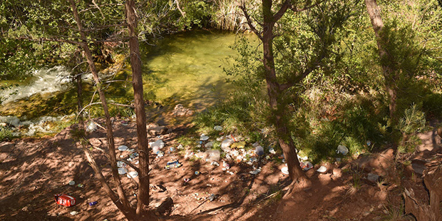 Trash left behind by visitors at Fossil Creek Springs before the permit system was implemented. (Cr...
