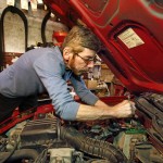 In this Tuesday, March 22, 2016, photo, auto mechanic Joe Valenti changes a battery in a Honda Acura at his garage in Dormont, Pa. Valenti has been keeping his customer's cars on the road since 1979. On Tuesday, June 28, 2016, the Commerce Department releases its third and final estimate of first-quarter gross domestic product. (AP Photo/Gene J. Puskar)