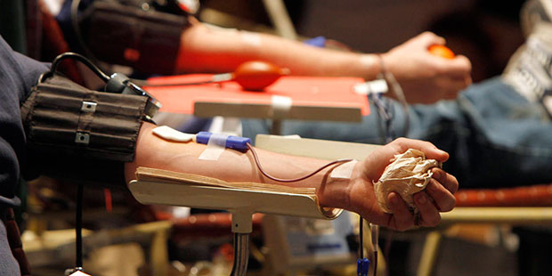 FILE - In this Dec. 20, 2011 file photo, donors give blood at a drive. (AP Photo/Toby Talbot, File)...