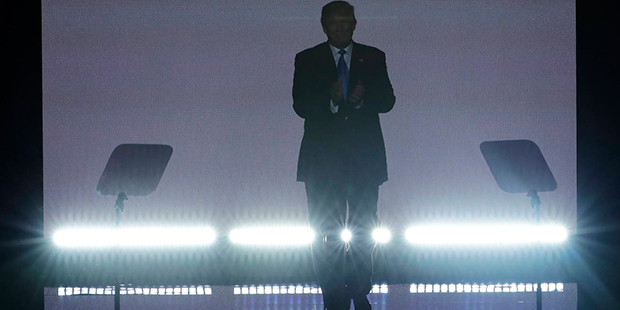 Republican Presidential Candidate Donald Trump applauds as he steps to the podium to introduce his ...