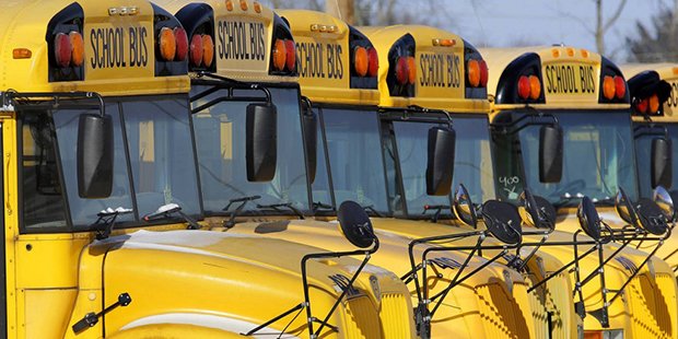 FILE - In this Jan. 7, 2015 file photo, public school buses are parked in Springfield, Ill. The laz...