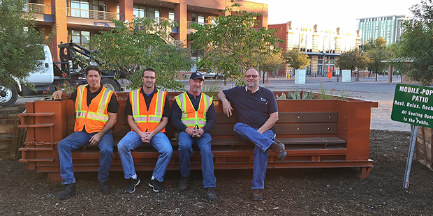 Tempe’s Public Works Department tests out the bench on the new mobile pop-up patio they created (...