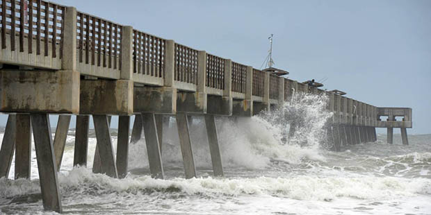 Waves crash off the pilings under the Jacksonville Beach Fishing Pier on Wednesday, Oct. 05, 2016, ...