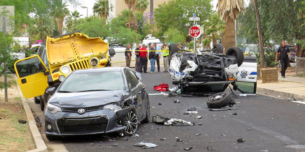 Investigators stand near the wreckage after a Department of Public Safety officer and a DPS dispatc...