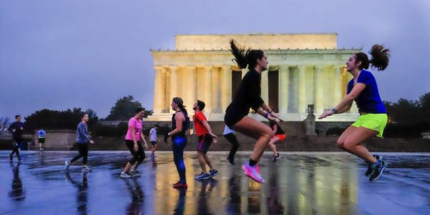 Early morning exercisers workout in the drizzle in front of the Lincoln Memorial in Washington, Wed...