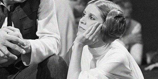 FILE - In this Nov. 13, 1978 file photo, Harrison Ford talks with Carrie Fisher during a break in t...