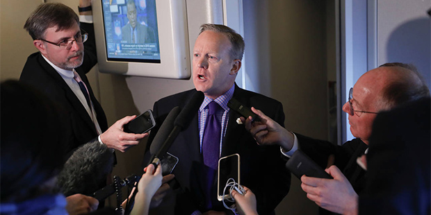 White House press secretary Sean Spicer speaks to reporters on Air Force One en route to Andrews Ai...