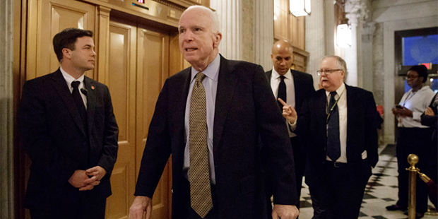 Senate Armed Services Committee chairman Sen. John McCain, R-Ariz., followed by Sen. Cory A. Booker...