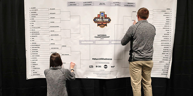Staff members for the NCAA places the names of the teams in the Sweet 16 on a bracket in the media work room before the start of practices, Thursday, March 23, 2017, at the East Regional of the NCAA college basketball tournament. (AP Photo/Julie Jacobson)