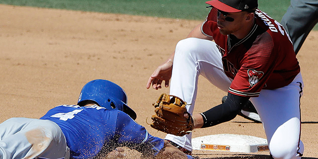 Kansas City Royals' Alex Gordon is tagged out by Arizona Diamondbacks' Brandon Drury trying to steal second during the fourth inning of a spring training baseball game Tuesday, March 21, 2017, in Scottsdale, Ariz. (AP Photo/Darron Cummings)