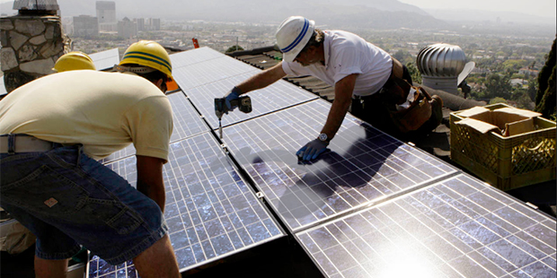 In this March 23, 2010, file photo, workers from California Green Design install solar electrical p...