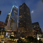 A light show illuminates Wilshire Grand Center, center left, to celebrate its grand opening, Friday, June 23, 2017, in Los Angeles. The 73-story, 1,100-foot-high structure is the tallest building west of the Mississippi. (AP Photo/Mark J. Terrill)