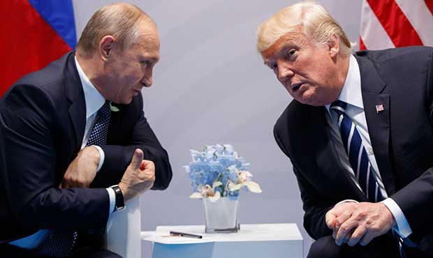 FILE - In this Friday, July 7, 2017, file photo U.S. President Donald Trump meets with Russian Pres...