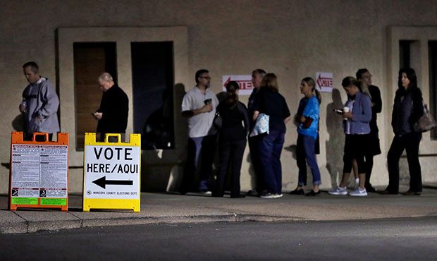 Voters wait for the polls to open early Tuesday, Nov. 8, 2016, in Phoenix. (AP Photo/Matt York)...