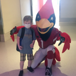Arizona Cardinals mascot Big Red poses with a child at the Give-A-Thon for Phoenix Children's Hospital in Phoenix, Ariz. on Aug. 17, 2017. (Matt Layman/KTAR.com)