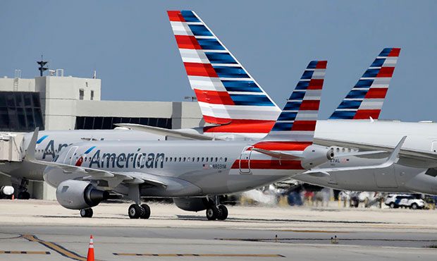 FILE - In this Wednesday, May 27, 2015, file photo, an American Airlines jet taxis to the gate at M...