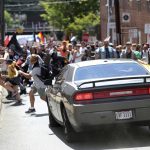 A vehicle drives into a group of protesters demonstrating against a white nationalist rally in Charlottesville, Va., Saturday, Aug. 12, 2017. The nationalists were holding the rally to protest plans by the city of Charlottesville to remove a statue of Confederate Gen. Robert E. Lee. There were several hundred protesters marching in a long line when the car drove into a group of them.   /The Daily Progress via AP)