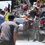 People fly into the air as a vehicle drives into a group of protesters demonstrating against a white nationalist rally in Charlottesville, Va., Saturday, Aug. 12, 2017. The nationalists were holding the rally to protest plans by the city of Charlottesville to remove a statue of Confederate Gen. Robert E. Lee. There were several hundred protesters marching in a long line when the car drove into a group of them. (Ryan M. Kelly/The Daily Progress via AP)