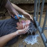 A counter-protester gets milk poured onto his face after getting pepper sprayed during a white nationalist rally on Saturday Aug. 12, 2017, in Charlottesville, Va. The nationalists had gathered to protest plans by the city of Charlottesville to remove a statue of Confederate Gen. Robert E. Lee and others arrived to protest the racism. (Shaban Athuman /Richmond Times-Dispatch via AP)