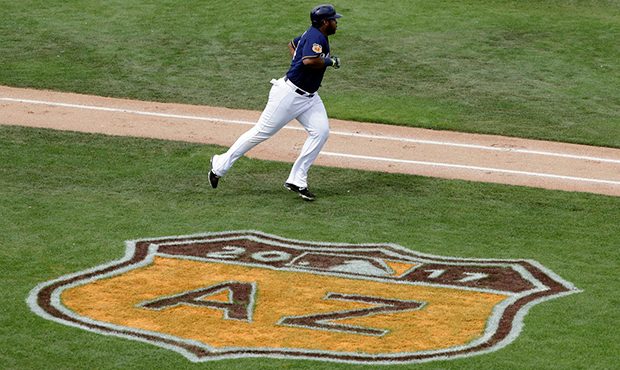 Milwaukee Brewers' Jesus Aguilar runs after hitting a home run during the fourth inning of a spring...