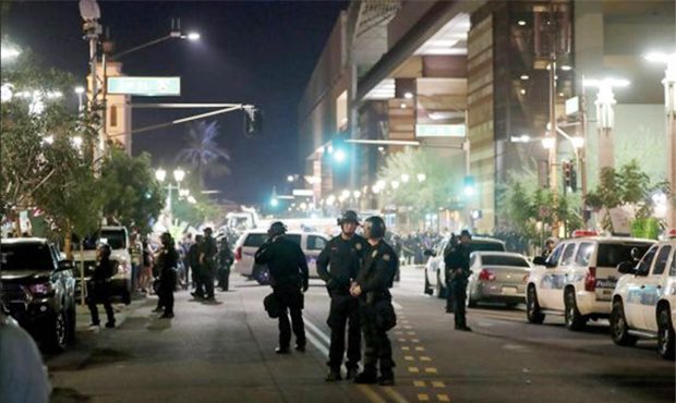 Phoenix police keep the streets clear as people protest outside the Phoenix Convention Center, Tues...