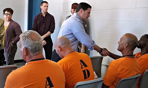Arizona Gov. Doug Ducey greets prisoners at the Lewis Prison in Buckeye, Ariz. during a visit to di...
